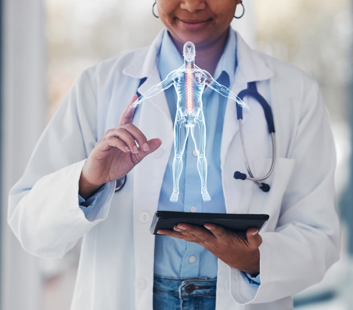 Doctor using tablet with anatomical hologram overlay