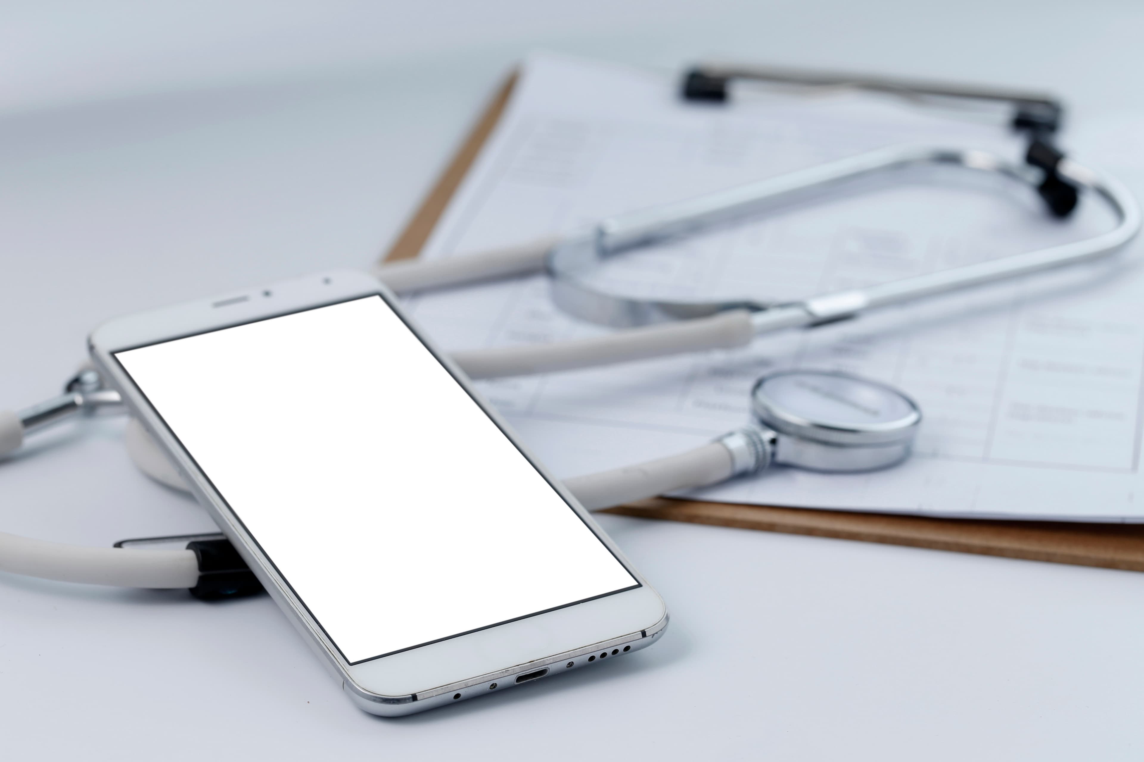 Phone and stethoscope on desk
